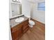 Bathroom with modern vanity, mirror, and wood-look flooring at 1045 Mobile St, Aurora, CO 80011