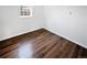 Bright bedroom featuring wood-look flooring and a window providing natural light at 1045 Mobile St, Aurora, CO 80011