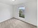 A carpeted bedroom features a window overlooking the street at 1045 Mobile St, Aurora, CO 80011