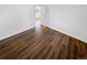 Bedroom showcasing wood-look floors and a doorway leading to another room at 1045 Mobile St, Aurora, CO 80011