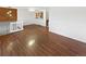 Hardwood living room with stairs to the left and view to the kitchen, with white wall trim at 1045 Mobile St, Aurora, CO 80011