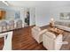 Bright living room with hardwood floors, neutral paint, and comfortable seating arrangement, virtually staged at 1045 Mobile St, Aurora, CO 80011