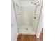 White shower enclosure with integrated shelving and modern fixtures at 1045 Mobile St, Aurora, CO 80011