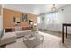 Bright living room with L-shaped sofa, coffee table, and wood-look floors at 855 N Pennsylvania St # 407, Denver, CO 80203