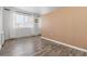 Living room with hardwood floors and peach accent wall at 855 N Pennsylvania St # 407, Denver, CO 80203