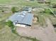 A high angle aerial shot of the shed row, loafing shed and horse paddocks at 595 W Oak Hill Ln, Castle Rock, CO 80108