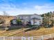 Large home aerial view showcasing the backyard, patio, landscaping, and perimeter fence at 595 W Oak Hill Ln, Castle Rock, CO 80108