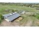 The aerial view reveals the large loafing shed and paddocks on this equestrian property at 595 W Oak Hill Ln, Castle Rock, CO 80108