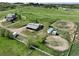 The aerial view captures the horse property with paddocks, loafing sheds, and riding areas at 595 W Oak Hill Ln, Castle Rock, CO 80108