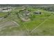 Stunning aerial view of the property with white fencing, horse paddock and neighboring mountain view at 595 W Oak Hill Ln, Castle Rock, CO 80108