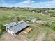 A well-maintained barn with fenced enclosure and separate shelters on a sprawling green property at 595 W Oak Hill Ln, Castle Rock, CO 80108