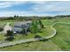 A lovely aerial of the property showing the home, white fencing and surrounding acreage at 595 W Oak Hill Ln, Castle Rock, CO 80108