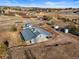 Aerial view of property featuring a long building with a metal roof with vehicles and trailers nearby at 595 W Oak Hill Ln, Castle Rock, CO 80108