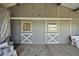 The interior of a barn with sliding doors, white trim and gray walls, along with a concrete floor at 595 W Oak Hill Ln, Castle Rock, CO 80108