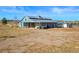 View of the horse barn featuring a metal roof, stalls, and room for parking farm equipment at 595 W Oak Hill Ln, Castle Rock, CO 80108