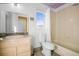 Functional bathroom with a vanity, toilet, and bathtub with a shower, featuring natural light at 595 W Oak Hill Ln, Castle Rock, CO 80108