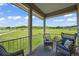 Enjoy peaceful views of the surrounding landscape from this covered patio with comfortable seating at 595 W Oak Hill Ln, Castle Rock, CO 80108