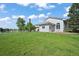 Well-maintained stucco house on a lush green lawn with mature trees at 595 W Oak Hill Ln, Castle Rock, CO 80108