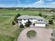 Stately home featuring a circular driveway, covered porch, and three-car garage on a sprawling lot at 595 W Oak Hill Ln, Castle Rock, CO 80108
