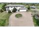 An exterior shot of this home features a circular drive and an attached two-car garage at 595 W Oak Hill Ln, Castle Rock, CO 80108
