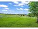 Lush green pasture enclosed by a white fence, offering an ideal space for horses to graze and roam at 595 W Oak Hill Ln, Castle Rock, CO 80108
