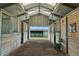 Interior view of the horse barn, showcasing clean and spacious stalls with metal and wood construction at 595 W Oak Hill Ln, Castle Rock, CO 80108