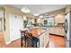 Eat-in kitchen featuring an island with wood top, stainless appliances, and wood floors at 595 W Oak Hill Ln, Castle Rock, CO 80108