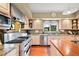 A kitchen with stainless steel appliances, granite countertops and white cabinets at 595 W Oak Hill Ln, Castle Rock, CO 80108