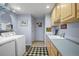 Functional laundry room with ample counter space and storage, plus washer and dryer at 595 W Oak Hill Ln, Castle Rock, CO 80108