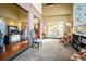 Open-concept living room with brick pillar and archway connecting to the dining area at 595 W Oak Hill Ln, Castle Rock, CO 80108