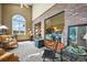 A cozy living room with large picture windows and views into other living spaces at 595 W Oak Hill Ln, Castle Rock, CO 80108