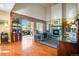 Inviting living room with a brick accent wall, fireplace, and large windows showcasing the outdoor view at 595 W Oak Hill Ln, Castle Rock, CO 80108