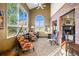 Bright living room with large windows, vaulted ceilings, and a charming brick fireplace at 595 W Oak Hill Ln, Castle Rock, CO 80108