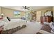 Spacious main bedroom with large windows, a ceiling fan, and an en-suite bathroom, offering comfort and convenience at 595 W Oak Hill Ln, Castle Rock, CO 80108