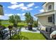 A patio with chairs, a fire pit, artificial turf, and landscaping, with pasture views at 595 W Oak Hill Ln, Castle Rock, CO 80108