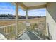 Inviting covered porch featuring wicker furniture and serene views of the surrounding landscape at 595 W Oak Hill Ln, Castle Rock, CO 80108