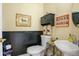 Charming powder room with wainscoting, pedestal sink, and unique decor at 595 W Oak Hill Ln, Castle Rock, CO 80108