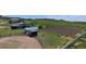 Aerial view of horse facilities, including riding arena, paddocks and a barn at 595 W Oak Hill Ln, Castle Rock, CO 80108