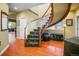 Elegant staircase with a curved railing, hardwood floors, and natural light at 595 W Oak Hill Ln, Castle Rock, CO 80108