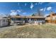 Spacious backyard with a well-maintained lawn, a brick patio, and a trampoline for outdoor enjoyment at 1756 S Memphis St, Aurora, CO 80017