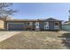 Charming single-story home with a well-maintained front yard, a newer garage door, and a welcoming entrance at 1756 S Memphis St, Aurora, CO 80017