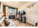 Functional home office with a comfortable sofa, modern desk setup, and ample natural light at 1756 S Memphis St, Aurora, CO 80017