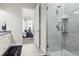 Bathroom with walk-in shower and view to bedroom with a bed and a set of windows at 20 Wilcox St # 203, Castle Rock, CO 80104
