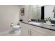 Clean bathroom features a framed art print, white single sink vanity, and dark shower curtain at 20 Wilcox St # 203, Castle Rock, CO 80104