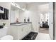 Contemporary bathroom boasts a double sink vanity, sleek fixtures, and access to bedroom at 20 Wilcox St # 203, Castle Rock, CO 80104