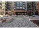 Paver entrance to the Encore building featuring ramps, plantings and storefronts at 20 Wilcox St # 203, Castle Rock, CO 80104