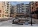 Entrance to the Encore building featuring landscaping, art installations and surrounding shops at 20 Wilcox St # 203, Castle Rock, CO 80104