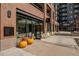 Commercial building exterior featuring brick facade, glass storefront, and seating area at 20 Wilcox St # 203, Castle Rock, CO 80104