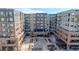 Exterior view of a contemporary apartment complex with inviting courtyard, surrounded by retail spaces and modern architectural details at 20 Wilcox St # 203, Castle Rock, CO 80104