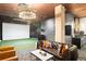 This room features a golf simulator, seating area, modern light fixture and bar with sink at 20 Wilcox St # 203, Castle Rock, CO 80104
